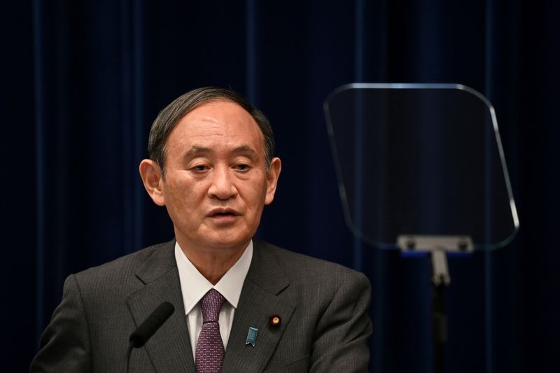 FILE PHOTO: Japan’s Prime Minister Yoshihide Suga holds a news