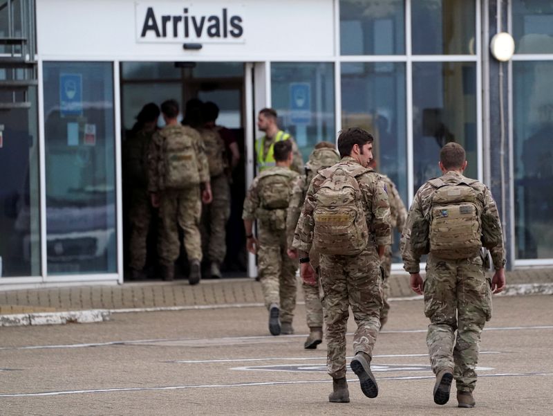 Members of the British armed forces arrive at RAF Brize