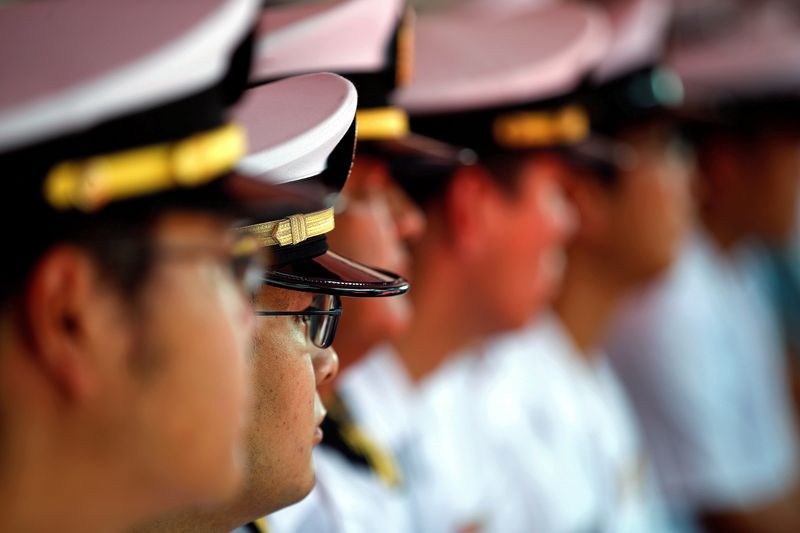 FILE PHOTO: FILE PHOTO: Japan’s Maritime Self-Defence Forces listen to