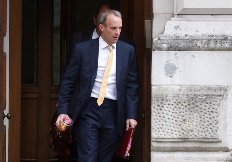 Britain’s Foreign Secretary Raab walks outside FCDO in London