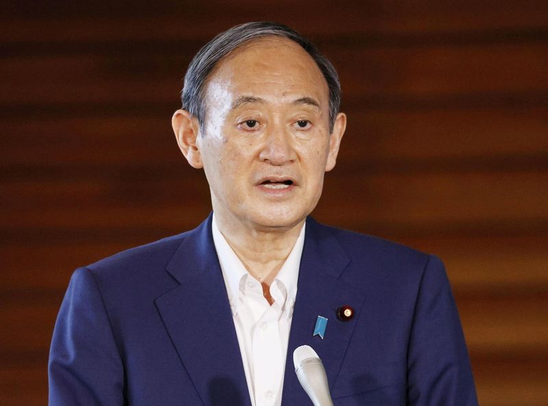 Japan’s Prime Minister Yoshihide Suga speaks to media after he