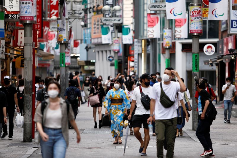 People walk in Shibuya shopping area, amid COVID-19 outbreak, in