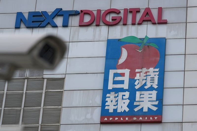 A surveillance camera is seen near an Apple Daily sign
