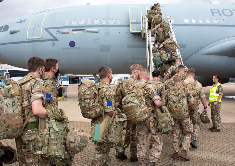 Military personnel board an RAF Voyager aircraft at RAF Brize