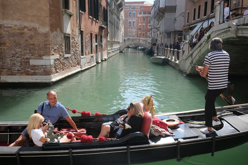 Tourists visit Venice as the municipality prepares to charge them