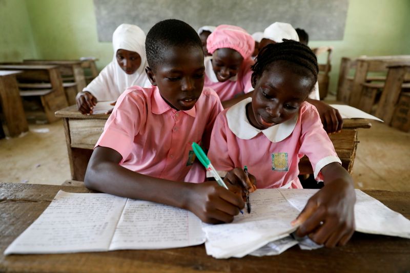 FILE PHOTO: Two children take notes during class in Kwara