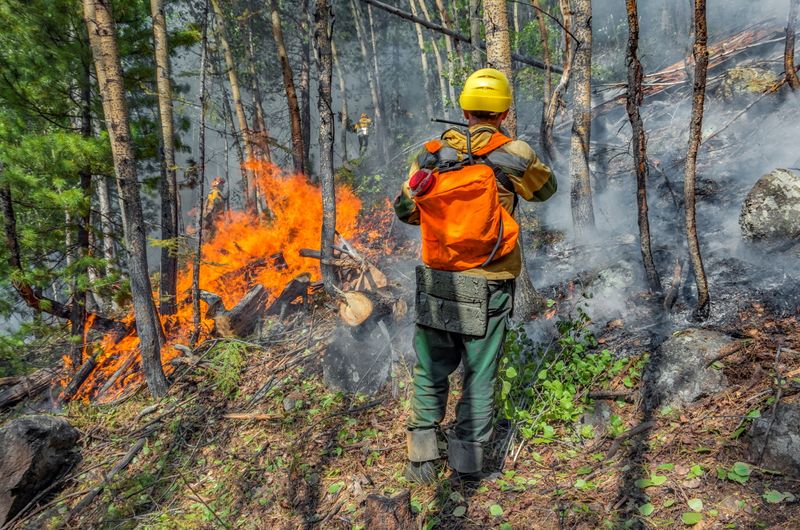 FILE PHOTO: Specialists work to extinguish wildfires in Yakutia
