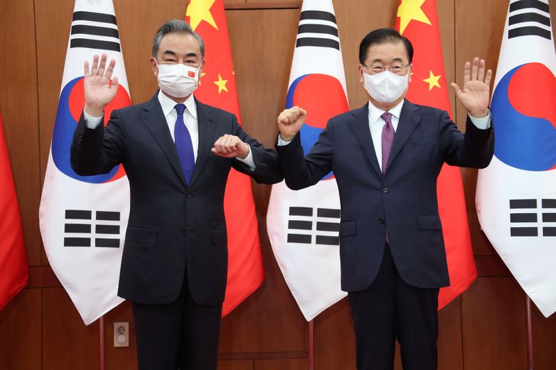 Chinese Foreign Minister Wang Yi poses for photographs with his