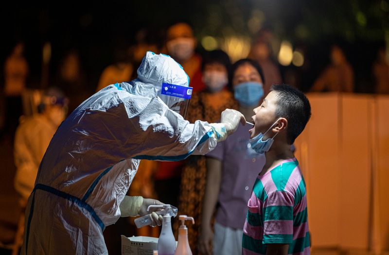 Medical worker collects a swab from a resident during a