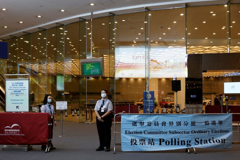 Security guards stand outside a polling station during voting of