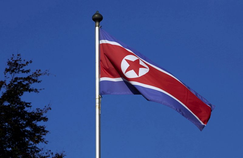 FILE PHOTO: A North Korean flag flies on a mast