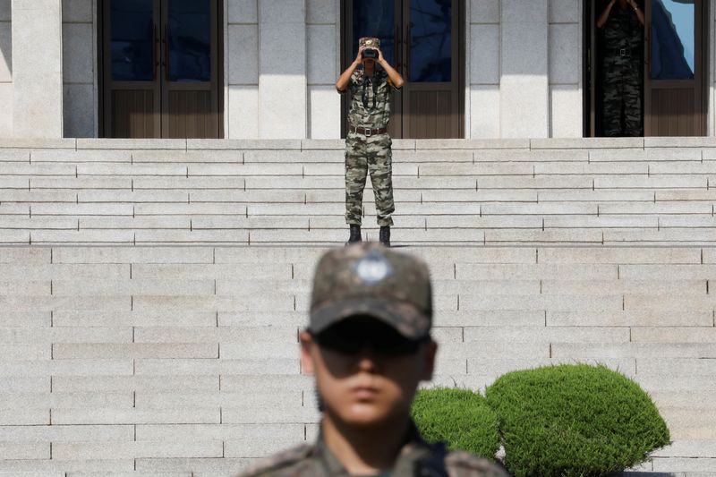 A North Korean soldier looks toward the south as a