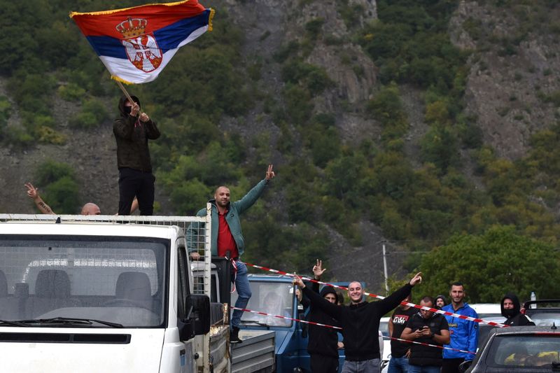 A Kosovo Serb is pictured waving a Serbian flag as