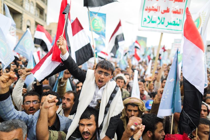 Supporters of Yemen’s Houthis shout slogans during a rally to