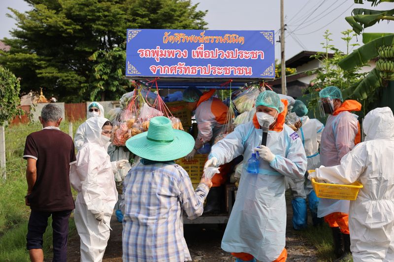Thai Buddhist monks craft traditional grocery truck to donate food
