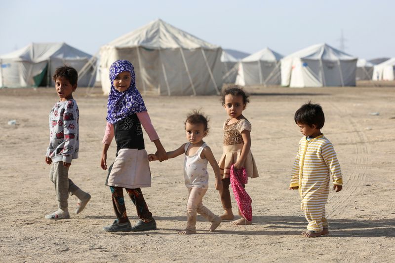 Children walk at a camp for people recently displaced by