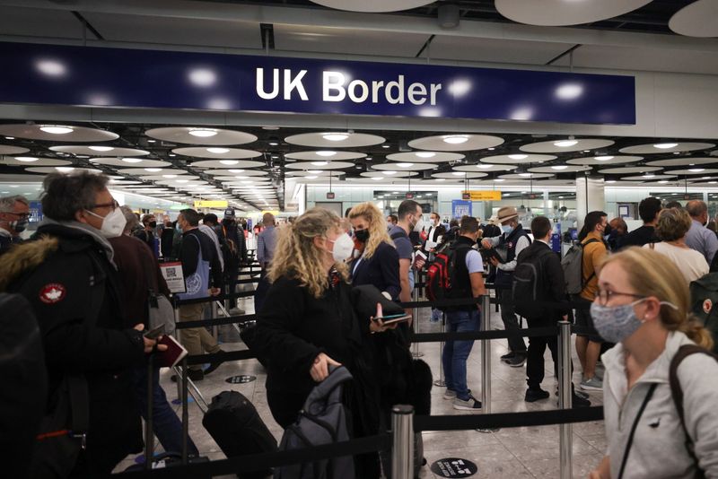 Arriving passengers queue at UK Border Control at the Terminal
