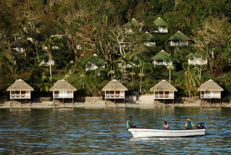 FILE PHOTO: People commute on boats to Port Vila, capital