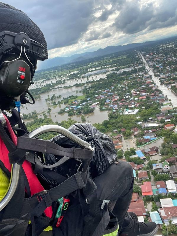 Powered paraglider delivers supplies to residents affected by flood in