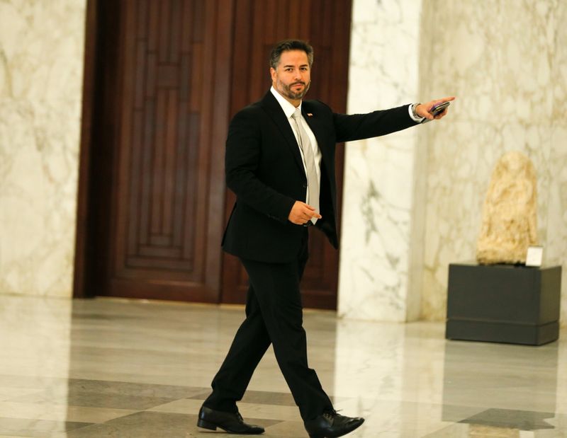 Lebanon’s Economy Minister Amin Salam gestures as he walks at