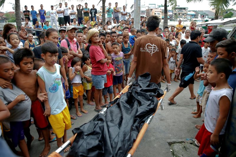 FILE PHOTO: Bodies of Noberto Maderal and fellow pedicab driver