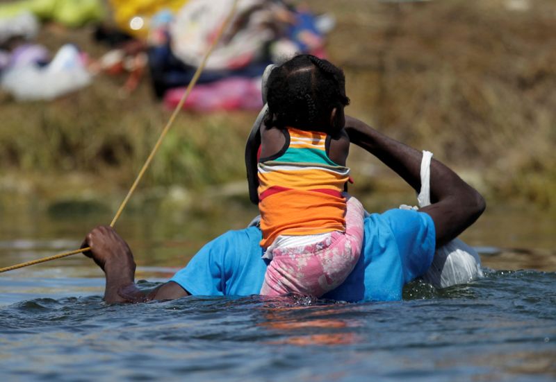 FILE PHOTO: Migrants seeking refuge in the U.S. cross Rio