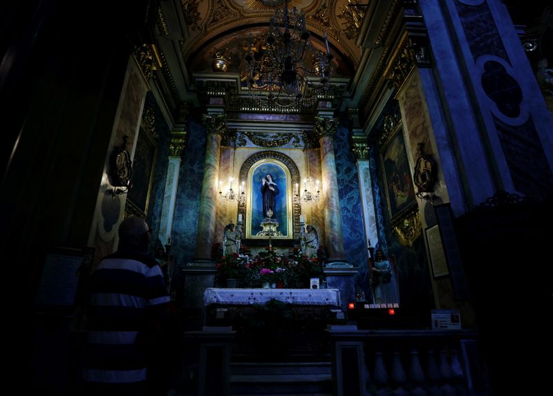 A man prays in Notre-Dame Basilica in Nice