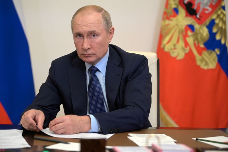 Russian President Vladimir Putin attends a meeting via a video