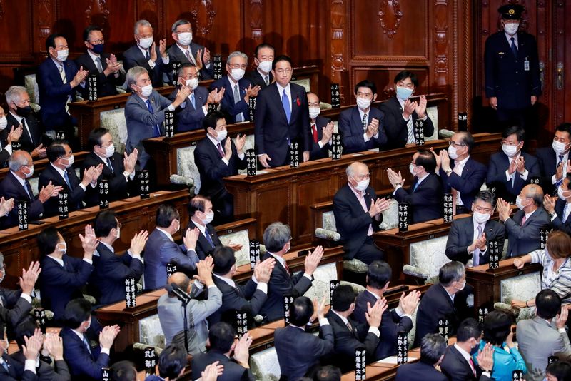 FILE PHOTO: Japan’s newly-elected Prime Minister Fumio Kishida is applauded