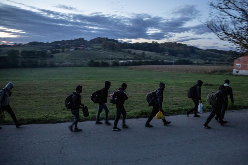 Migrants gather before trying to cross the Bosnia-Croatia border near