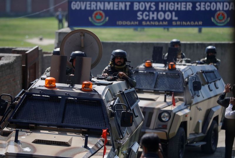 FILE PHOTO: Indian security forces keep guard atop armoured vehicles