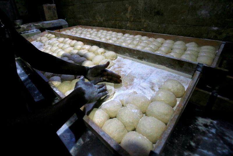 FILE PHOTO: A worker prepares bread dough before baking in