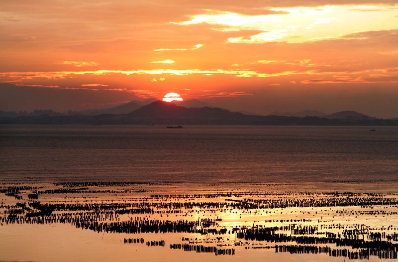 FILE PHOTO: The sun sets over China’s southeastern coast of