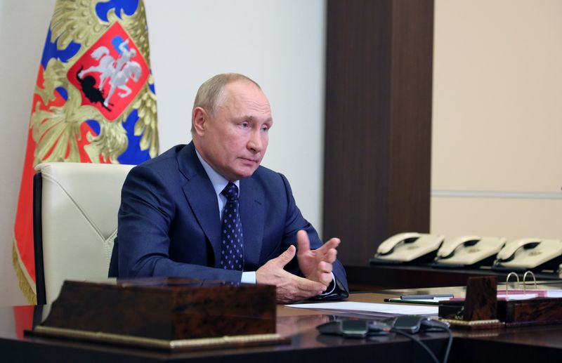Russian President Putin attends a meeting with members of the