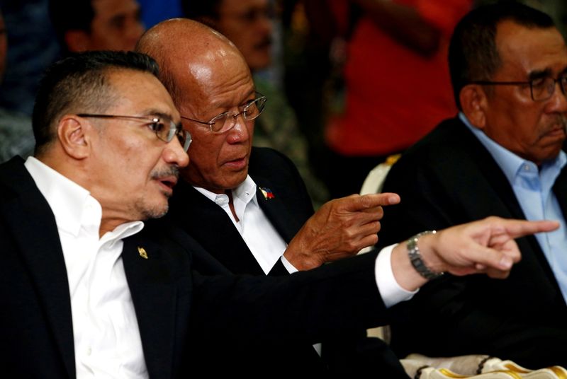 FILE PHOTO: Malaysia’s Defence Minister Hishammuddin Hussein speaks to Philippines’s