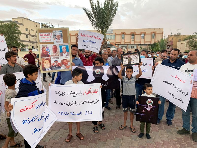 Families of the victims gather during a protest demanding justice
