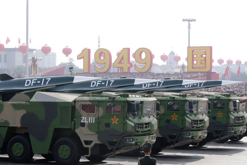Military vehicles carrying hypersonic missiles DF-17 travel past Tiananmen Square