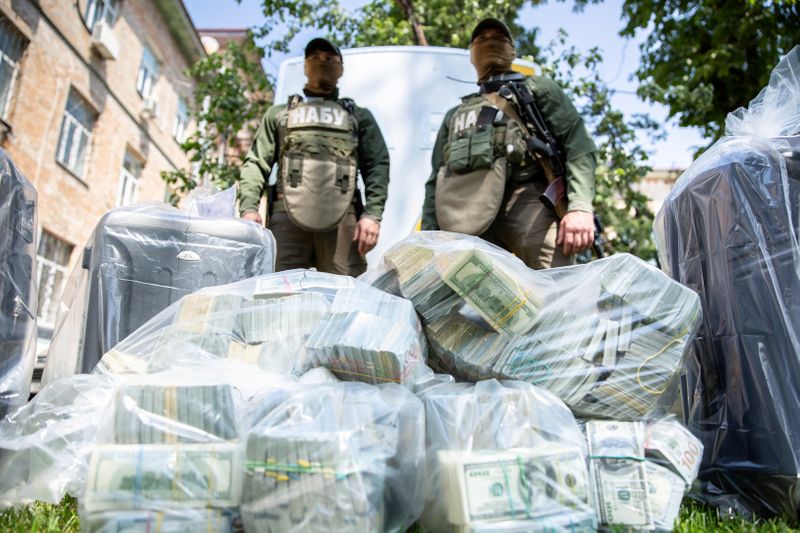 Officers of the National Anti-Corruption Bureau of Ukraine stand next