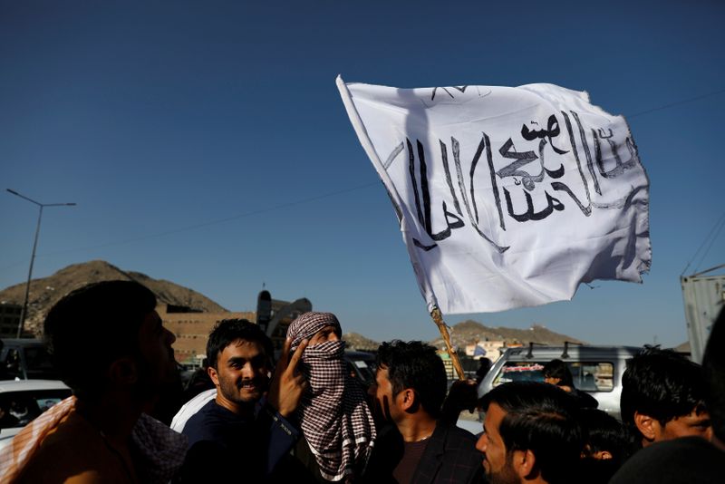 A member of the Taliban holds a flag in Kabul
