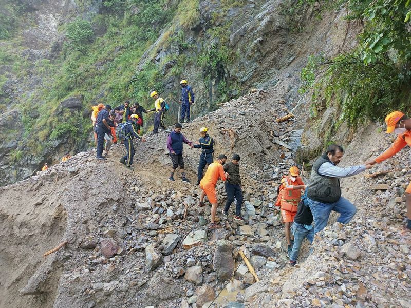 Members of National Disaster Response Force evacuate stranded people following