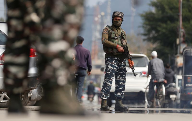 Indian Central Reserve Police Force personnel stand guard on a