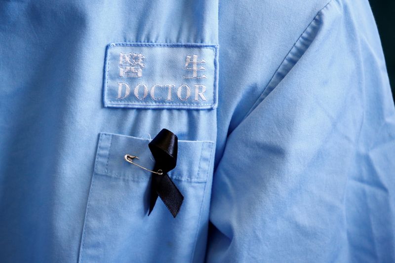 FILE PHOTO: A doctor wears a protest ribbon during a