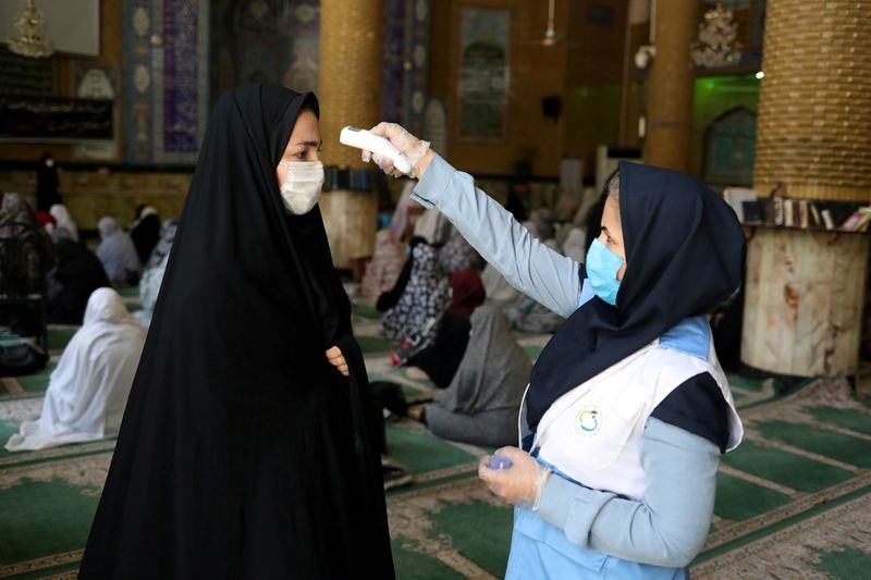 FILE PHOTO: An Iranian woman wearing a protective face mask