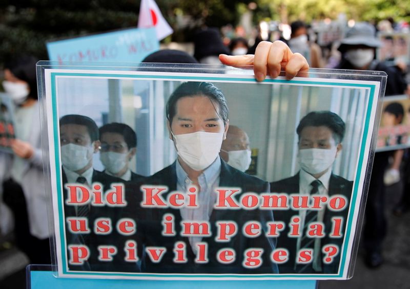 Protesters hold banners during a march against the marriage between