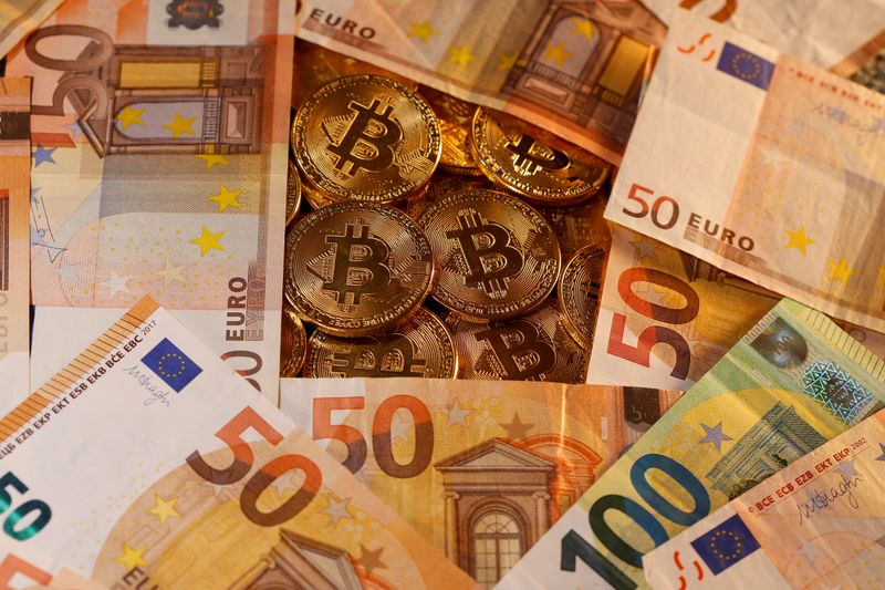 Representations of virtual currency Bitcoin and euro banknotes are seen