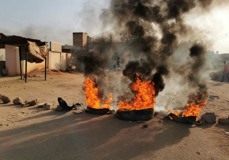 FILE PHOTO: Protesters block a road in Khartoum