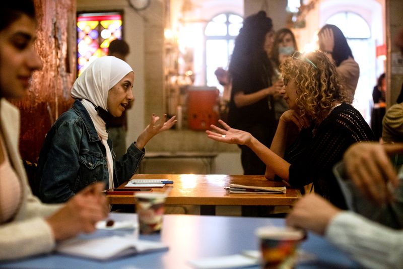 Palestinian woman chats with Israeli woman during language exchange program