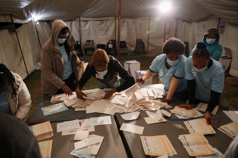 FILE PHOTO: Election officials count ballots after the closing of