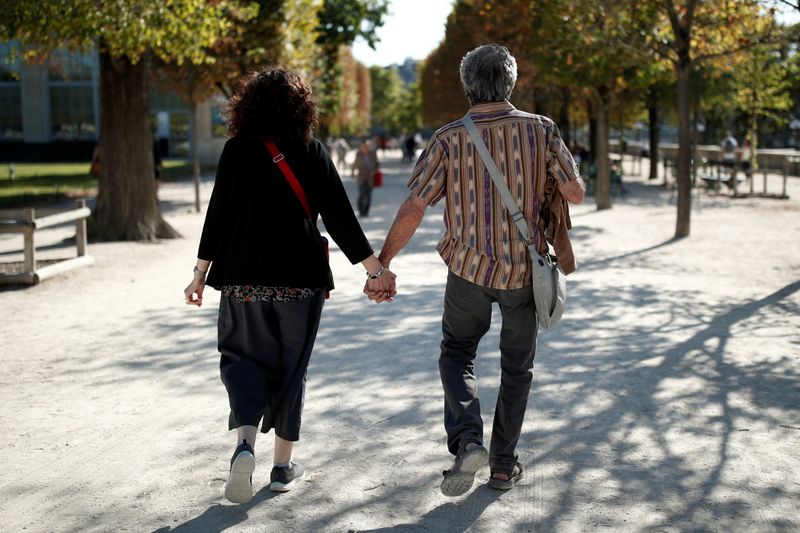 A couple of elderly people walks in the Tuileries Garden