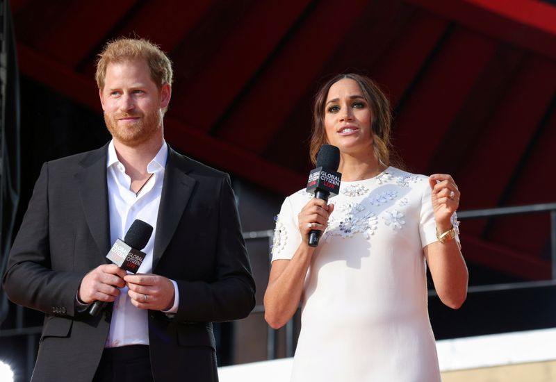 FILE PHOTO: Britain’s Prince Harry and Meghan Markle speak at